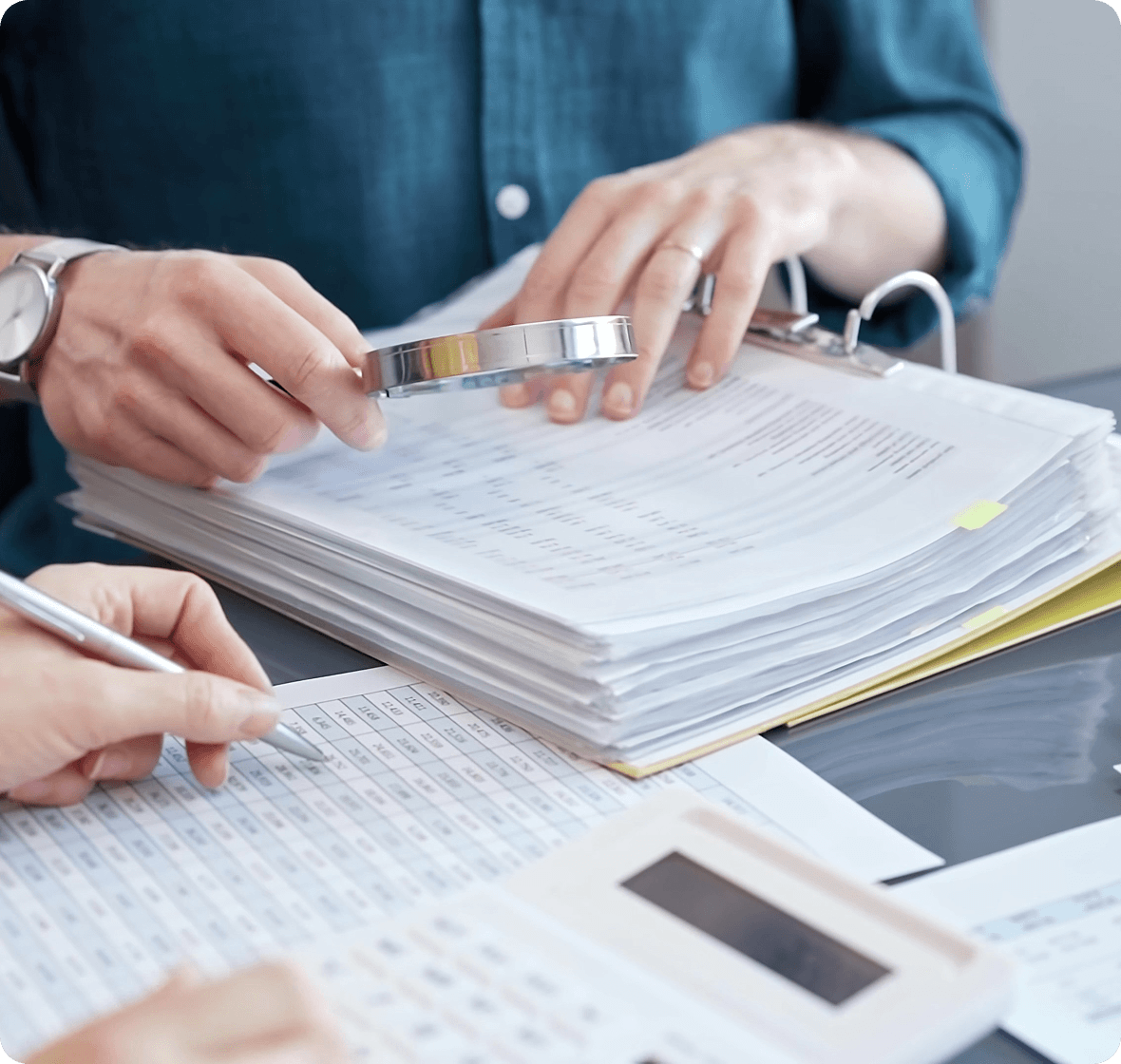 Examining reports with calculator nearby
